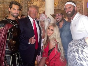 Paulina Gretzky, front in Baywatch red, and beau Dustin Johnson, far right, celebrate Halloween with Donald Trump.