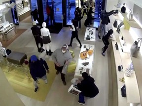 Surveillance footage shows suspects are seen raiding a Louis Vuitton store in Los Angeles.