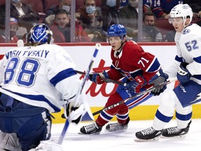 Montreal Canadiens centre Jake Evans (71) tries to get a shot off against Tampa Bay Lightning goaltender Andrei Vasilevskiy (88) as Lightning defenceman Cal Foote (52) pressures him during first-period NHL action in Montreal, on Tuesday, December 7, 2021.