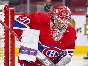 Montreal Canadiens' Cayden Primeau takes a shot off his shoulder during second period at the Bell Centre on Thursday, Dec. 16, 2021.