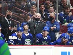 Canucks head coach Bruce Boudreau looks on from the bench during their NHL game against the Columbus Blue Jackets at Rogers Arena Dec. 12, 2021 in Vancouver.
