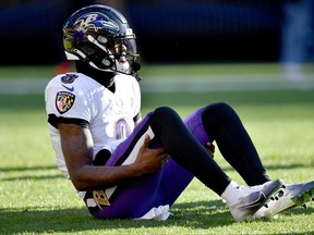 Ravens’ Lamar Jackson winces in pain after injuring his ankle against the Browns in Cleveland yesterday. The injury doesn’t appear to be serious.