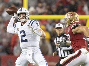 Colts quarterback Carson Wentz (left) passes the ball against 49ers defensive end Nick Bosa (right) during second quarter NFL action at Levi's Stadium in Santa Clara, Calif., Oct. 24, 2021.