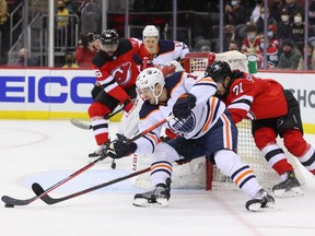 Edmonton Oilers left wing Tyler Benson (16) skates with the puck against New Jersey Devils defenseman Jonas Siegenthaler (71) during the first period at Prudential Center on Dec. 31, 2021.