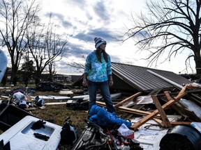 Ashley McKnight removes belonging from her damaged home in Mayfield, Kentucky, Tuesday, Dec. 14, 2021.