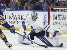 Maple Leafs goaltender Joseph Woll makes the first save of his NHL career, stopping Sabres' Dylan Cozens in the opening minute of his debut on Saturday, Nov. 13, 2021, in Buffalo, N.Y.