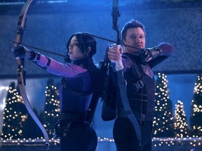 Kate Bishop (Hailee Steinfeld) and Hawkeye (Jeremy Renner) are superheroes helping out during the holidays in "Hawkeye."