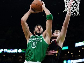 Celtics forward Jayson Tatum (0) drives the ball against Cavaliers forward Dean Wade during NBA action at TD Garden in Boston, Dec. 22, 2021.