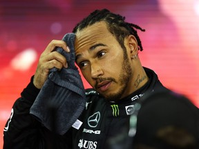 Second placed and championship runner up Lewis Hamilton of Great Britain and Mercedes GP looks dejected in parc ferme during the F1 Grand Prix of Abu Dhabi at Yas Marina Circuit on Dec. 12, 2021 in Abu Dhabi, United Arab Emirates.