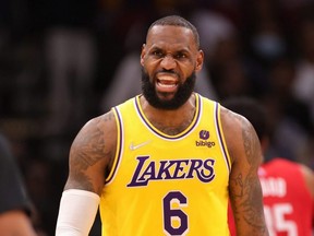 Lakers star LeBron James reacts to a play during the first half against the Rockets at Toyota Center in Houston, Tuesday, Dec. 28, 2021.