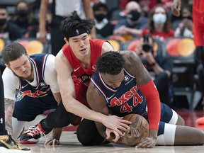 Toronto Raptors forward Yuta Watanabe (18) battles for the ball with Philadelphia 76ers forward Paul Reed (44)) at Scotiabank Arena.