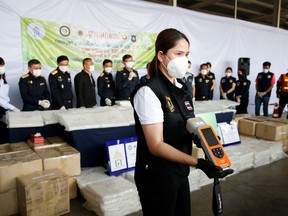 Thai authorities show the result of machine test as they seized 897 kilograms of crystal methamphetamine after Thai customs intercepted packages headed for Taiwan, in Bangkok, Thailand, Dec. 4, 2021.