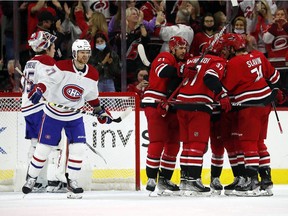 Hurricanes' Nino Niederreiter (21) left, celebrates his goal with teammates as Canadiens' Brett Kulak and goaltender Sam Montembeault look on Thursday night in Raleigh, N.C.