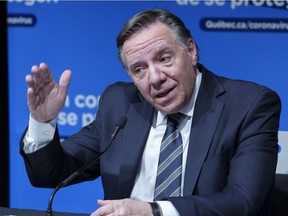 Quebec Premier François Legault responds to a question during a news conference in Montreal, on Thursday, December 16, 2021.