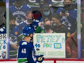 A young fan reacts after receiving a puck from Vancouver Canucks forward Elias Pettersson (40) prior to the start of a game against the Carolina Hurricanes at Rogers Arena.