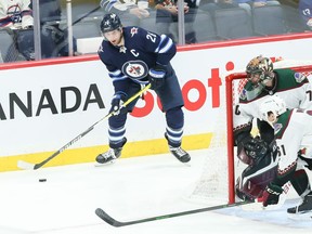 Winnipeg Jets forward Blake Wheeler (26) tries to make a pass behind Arizona Coyotes goalie Karel Vejmelka (70) during the third period at Canada Life Centre in Winnipeg on Nov. 29. Wheeler, who will play his 1,000th NHL on Sunday, was drafted as a drafted the 17-year-old on June 26, 2004 by the Arizona Coyotes fifth overall out of Breck High School in Golden Valley, Minn., — a pick after Carolina snagged the man he'd learn so much from later on in his career, Andrew Ladd.