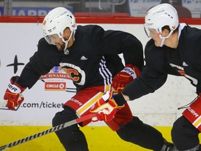 Calgary Flames Oliver Kylington and Nikita Zadorov during practice at the Scotiabank Saddledome on Monday, Dec. 27, 2021.