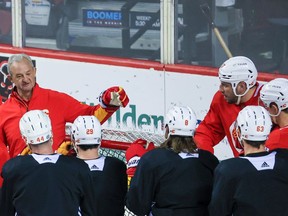 Flames head coach Darryl Sutter talks with the team during practice at the Scotiabank Saddledome in Calgary on Wednesday.