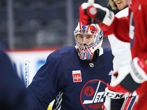 Goaltender Connor Hellebuyck sporting a new mask to match the heritage jerseys during Winnipeg Jets practice at Canada Life Centre on Monday Nov. 8, 2021.