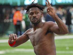 Buccaneers wide receiver Antonio Brown gestures to the crowd as he leaves the field on Sunday.