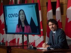 Chief Public Health Officer Theresa Tam, left, appears via video conference as Prime Minister Justin Trudeau attends a news conference in Ottawa in 2021.