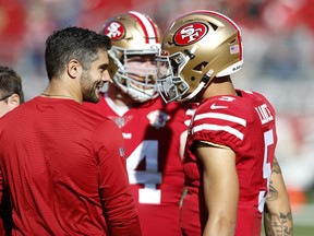 Jimmy Garoppolo (left) of the San Francisco 49ers talks with Trey Lance.