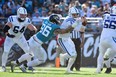 Carson Wentz of the Indianapolis Colts is sacked by Adam Gotsis of the Jacksonville Jaguars.