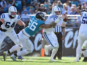 Carson Wentz of the Indianapolis Colts is sacked by Adam Gotsis of the Jacksonville Jaguars.