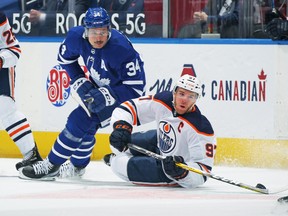 Connor McDavid #97 of the Edmonton Oilers battles for the puck against Auston Matthews #34 of the Toronto Maple Leafs during the first period an NHL game at Scotiabank Arena on March 29, 2021 in Toronto.