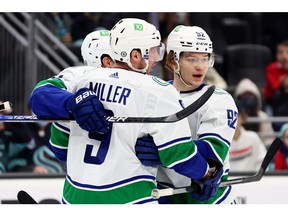 Vasily Podkolzin #92 of the Vancouver Canucks celebrates with his teammates after his goal against the Seattle Kraken during the first period at Climate Pledge Arena on January 01, 2022 in Seattle, Washington.