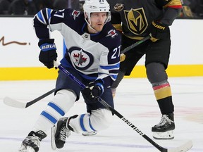 Nikolaj Ehlers of the Winnipeg Jets skates with the puck ahead of Nolan Patrick of the Vegas Golden Knights in the first period of their game at T-Mobile Arena on Jan. 2, 2022 in Las Vegas. The Jets defeated the Golden Knights 5-4 in overtime.