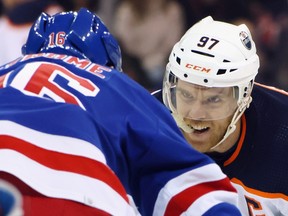 Connor McDavid (97) of the Edmonton Oilers faces off with Ryan Strome (16) of the New York Rangers at Madison Square Garden on Monday, Jan. 03, 2022, in New York City.