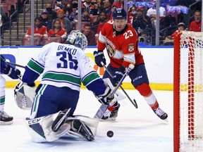 Carter Verhaeghe of the Florida Panthers gets the puck behind Thatcher Demko of the Vancouver Canucks during the first period but it doesn't enter the net at the FLALive Arena on January 11, 2022 in Sunrise, Florida.