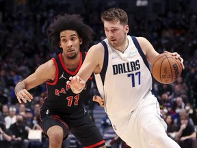Mavericks' Luka Doncic drives to the basket as Raptors forward Justin Champagnie defends during NBA action in Dallas, Wednesday, Jan. 19, 2022.