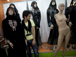 Women's clothes are displayed on mannequins as a man shops in a new market on Nov. 1, 2010 in Herat, Afghanistan.