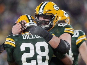 Packers running back A.J. Dillon is congratulated by centre Lucas Patrick, right, after a touchdown during the fourth quarter of a game against the Vikings at Lambeau Field in Green Bay, Wis., Sunday, Jan. 2, 2022.