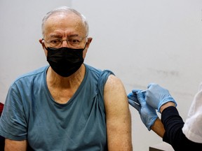 FILE PHOTO: People receive the fourth dose of coronavirus disease (COVID-19) vaccine in Tel Aviv