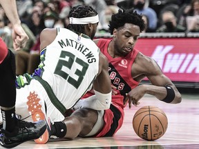Raptors' OG Anunoby and Bucks' Wesley Matthews battle for a loose ball in the second quarter at Fiserv Forum on Wednesday, Jan. 5, 2022.