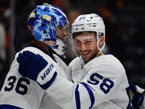 Toronto Maple Leafs left wing Michael Bunting (58) celebrates with goaltender Jack Campbell.