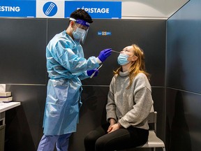 Jennifer Eriksson is tested as passengers arrive at Toronto's Pearson airport after mandatory coronavirus testing took effect for international arrivals in Mississauga, Feb. 1, 2021.
