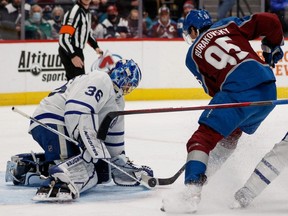 Maple Leafs goaltender Jack Campbell makes a save against Avalanche left wing Andre Burakovsky during NHL action at Ball Arena in Denver, Saturday, Jan. 8, 2022.