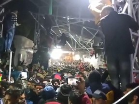 This frame grab from an NNIS video taken Saturday, Jan. 1, 2022 shows a packed crowd of devotees at the Vaishno Devi shrine, one of India's most revered Hindu sites, near Katra town in Jammu and Kashmir union territory.