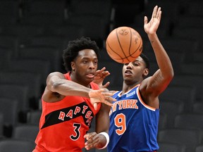 Raptors' OG Anunoby passes the ball away from New York Knicks' RJ Barrett during the first half at Scotiabank Arena on Sunday, Jan. 2, 2022.