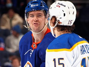 Ross Johnston of the New York Islanders exchanges words with John Hayden of the Buffalo Sabres during the second period at the UBS Arena on Dec. 30, 2021 in Elmont, N.Y.
