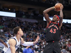 Toronto Raptors forward Pascal Siakam (right) shoots over Dallas Mavericks centre Dwight Powell during the second half of an NBA game on Jan. 19, 2022, at American Airlines Center.