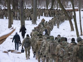 Civilian participants in a Kyiv Territorial Defence unit train in a forest in Kyiv, Ukraine, Saturday, Jan. 22, 2022.