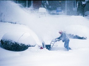 Homeowners attempt to clear snow from driveways on Jan. 17, 2022, in Ajax, Ont.