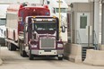 A trucker waits at the Canada Customs booth and the US/Canada border in Sarnia, Ontario on March 16, 2020.