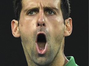 Serbia's Novak Djokovic reacts after a point against Austria's Dominic Thiem during their men's singles final match on Day 14 of the Australian Open tennis tournament in Melbourne. The vaccine-skeptic tennis ace was held after arrival in Australia on January 5, 2021, his visa revoked for failing to meet the country's tough pandemic restrictions.