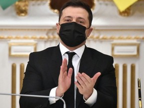 Ukrainian President Volodymyr Zelensky applauds after his Azerbaijanian counterpart's statement in Kyiv on Jan. 14, 2022.